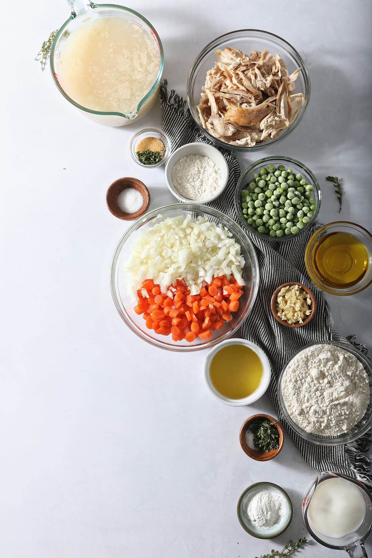 Ingredients to make classic Chicken and Dumplings in bowls on marble