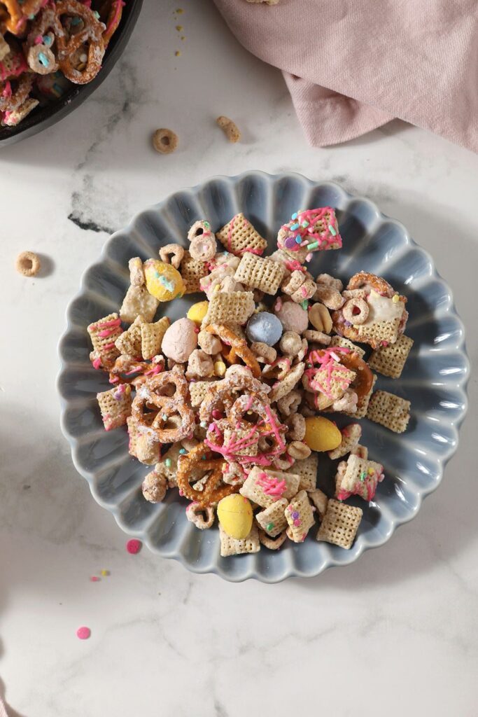 A blue plate of Easter snack mix on marble