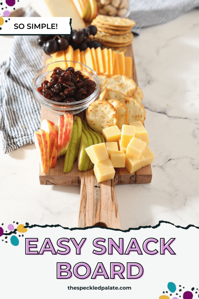 A rectangular board holding cheese, fruit and crackers with the text Easy Snack Board