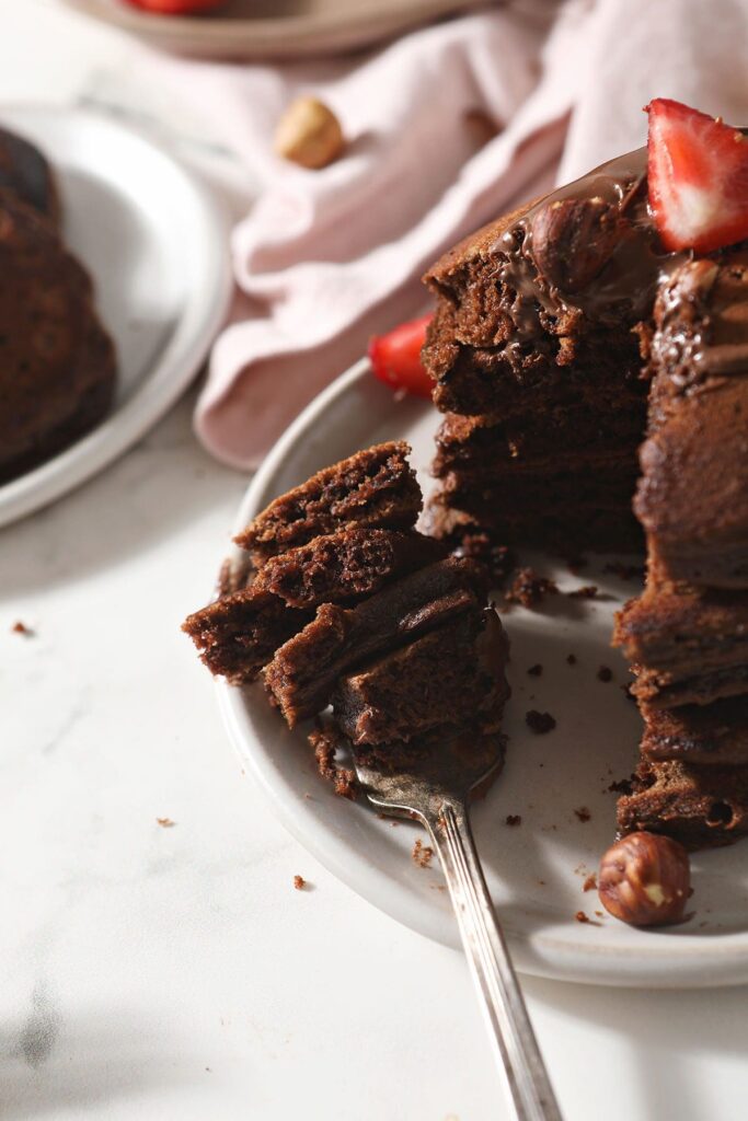 Close up of a fork holding several bites of Chocolate Nutella Pancakes