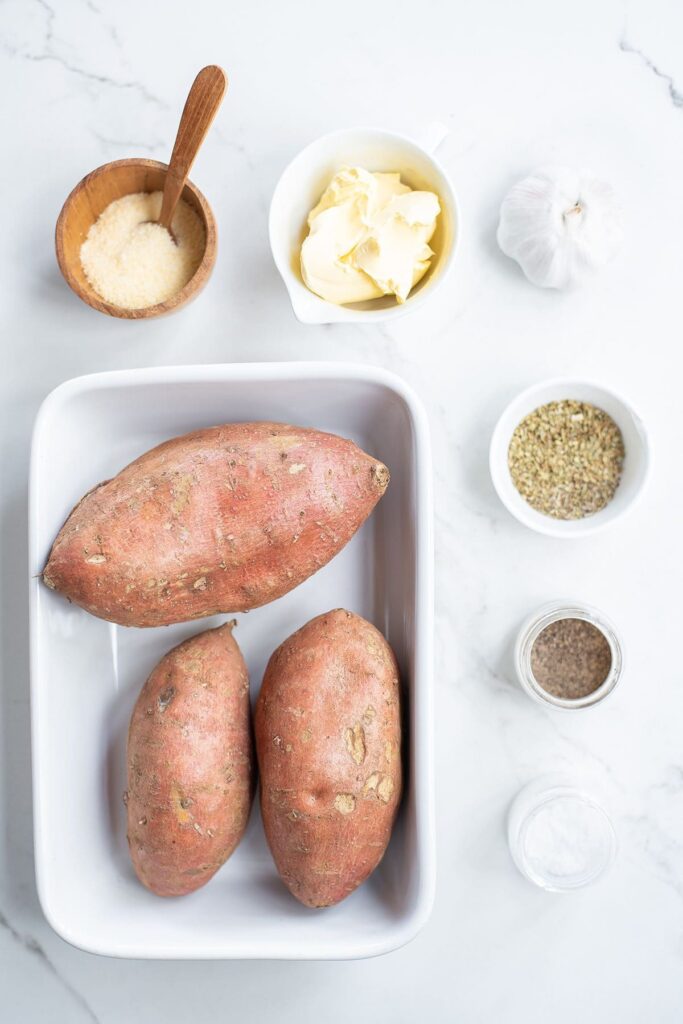 Sweet potatoes and other ingredients to make a sweet potato side dish recipe on marble