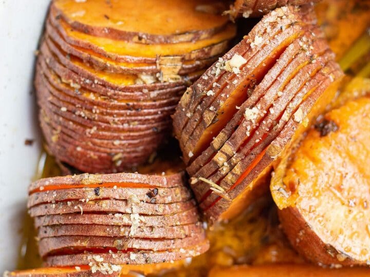 Close up of hasselback sweet potatoes after roasting in a baking dish