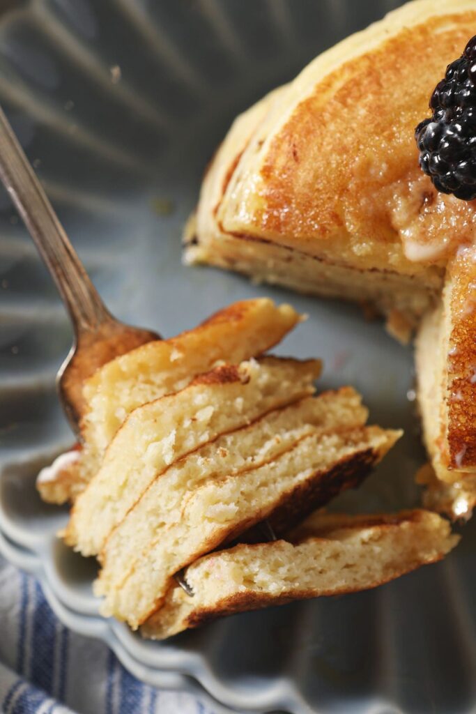 Pancake on a fork next to a stack