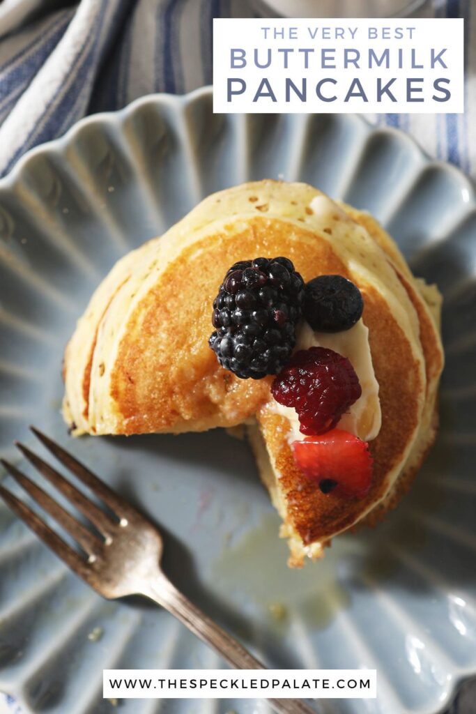 A cut-into stack of pancakes with berries on top with the text the very best buttermilk pancakes