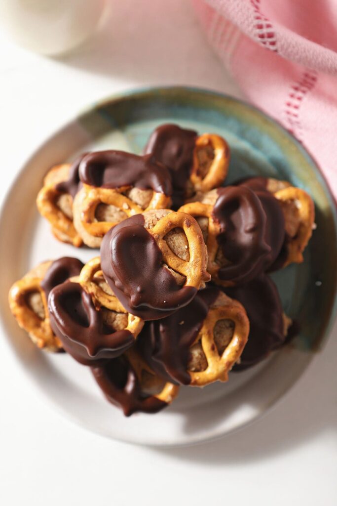 A plate of Peanut Butter Pretzel Bites next to a pink towel