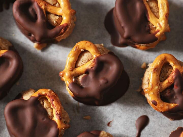 Close up of chilled Chocolate-Covered Peanut Butter Pretzels on a sheet pan