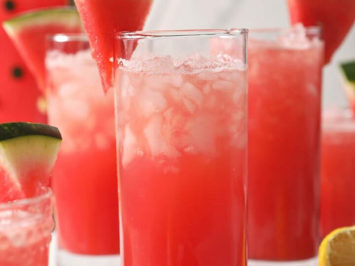 Four glasses of watermelon lemonade on marble