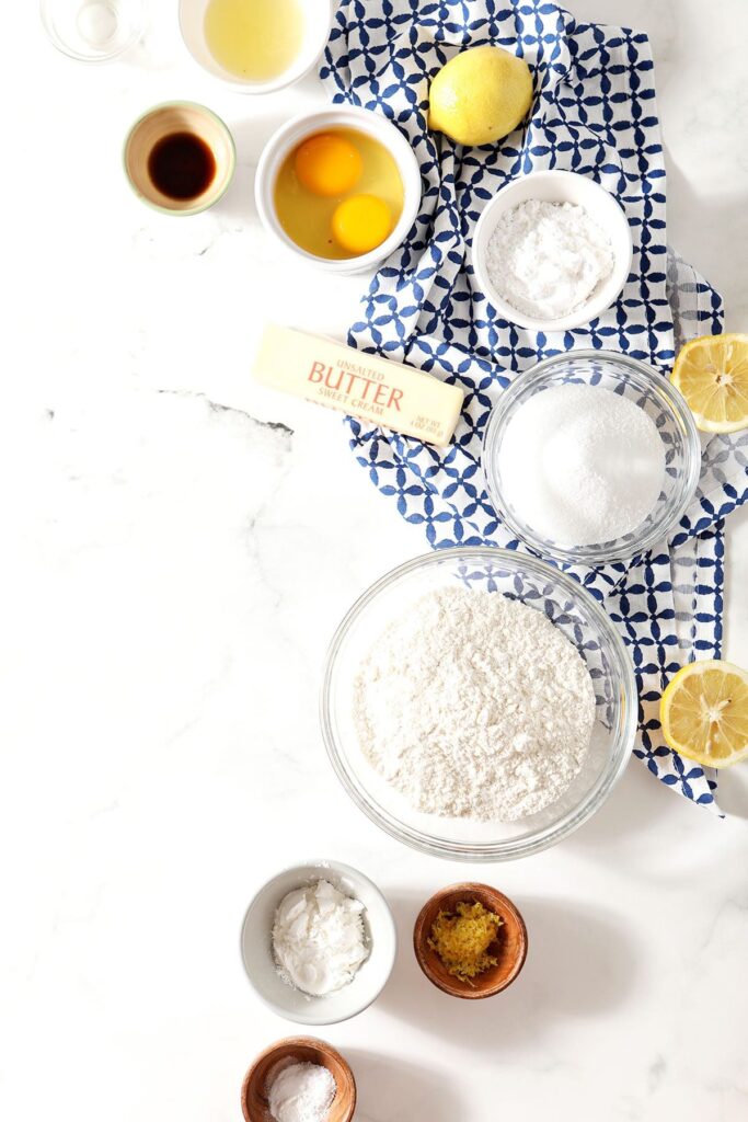 Ingredients to make Cooler Cookies in bowls on marble with a blue geometric towel