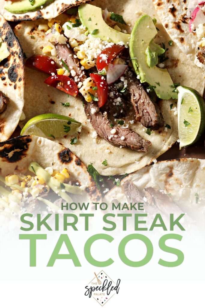 Close up of steak tacos on a wooden board with all the toppings with the text how to make skirt steak tacos