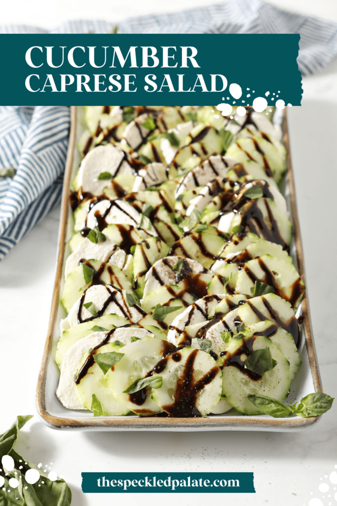 A platter of caprese salad on marble with the text cucumber caprese salad