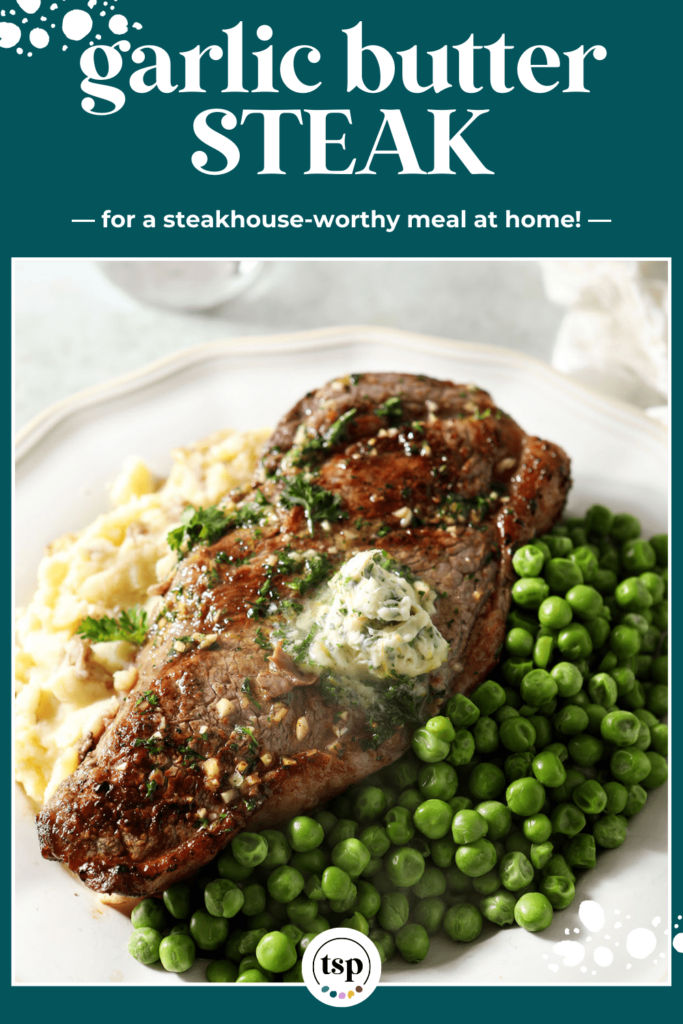 A whole steak on a plate with peas and mashed potatoes topped with herb butter with the text garlic butter steak for a steakhouse-worthy meal at home!