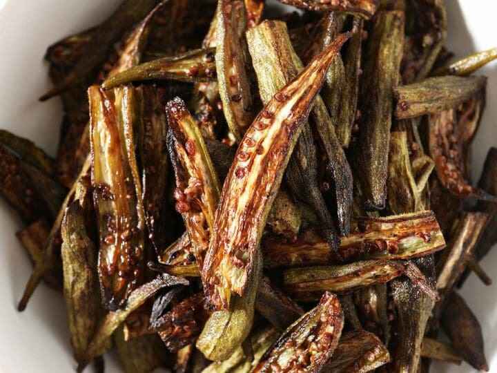 A bowl of oven roasted okra on marble
