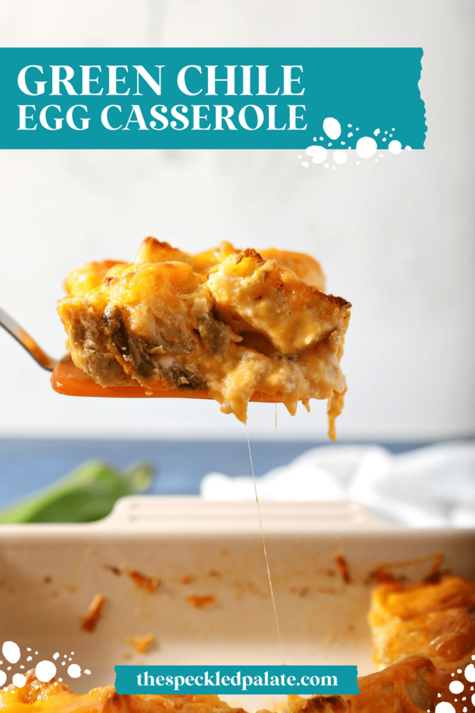 An orange spatula lifts up a gooey slice of breakfast casserole with the text green Chile egg casserole