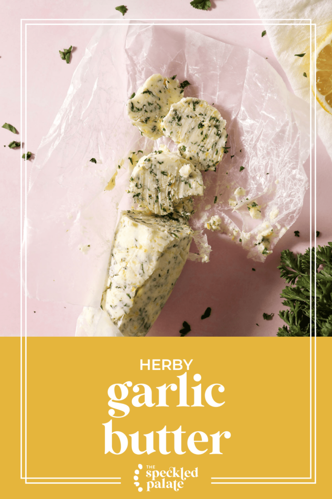 A log of compound butter and slices of it with the text herby garlic butter