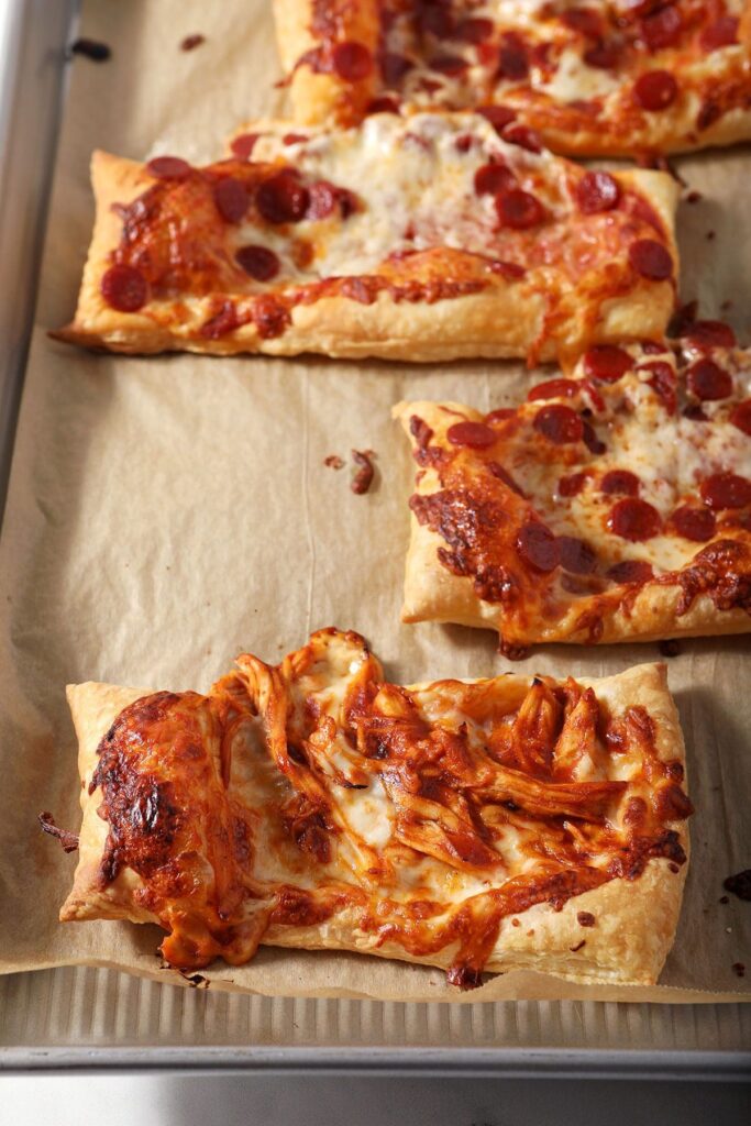 Puff pastry pizzas on a baking sheet