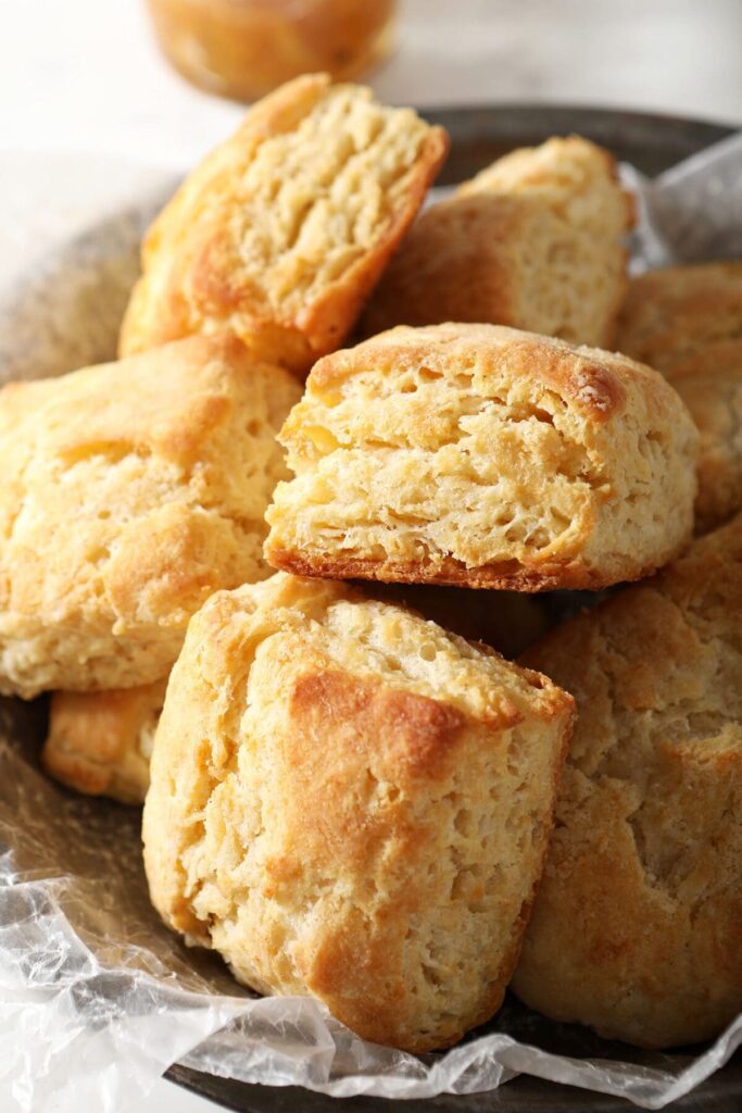 A stack of buttery biscuits in a serving bowl