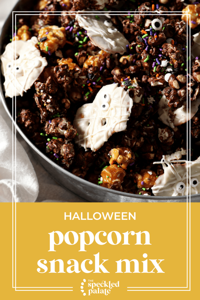 A bowl of a chocolate, caramel and white chocolate popcorn mix with the text halloween popcorn snack mix