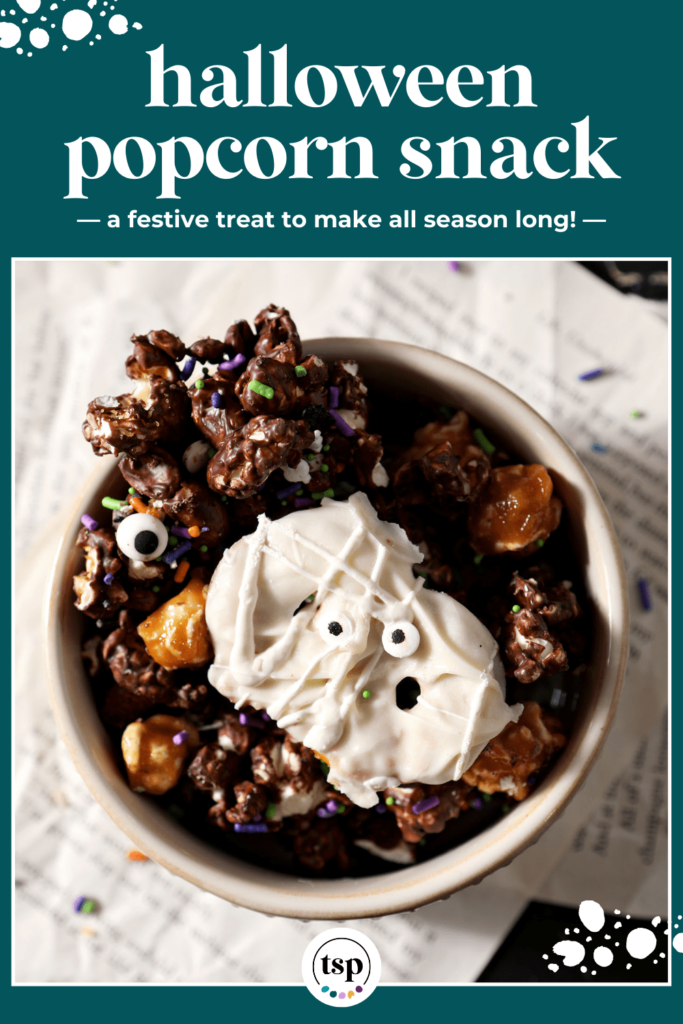 A bowl of a chocolate popcorn snack mix with halloween pretzels in it in a bowl with the text halloween popcorn snack a festive treat to make all season long!