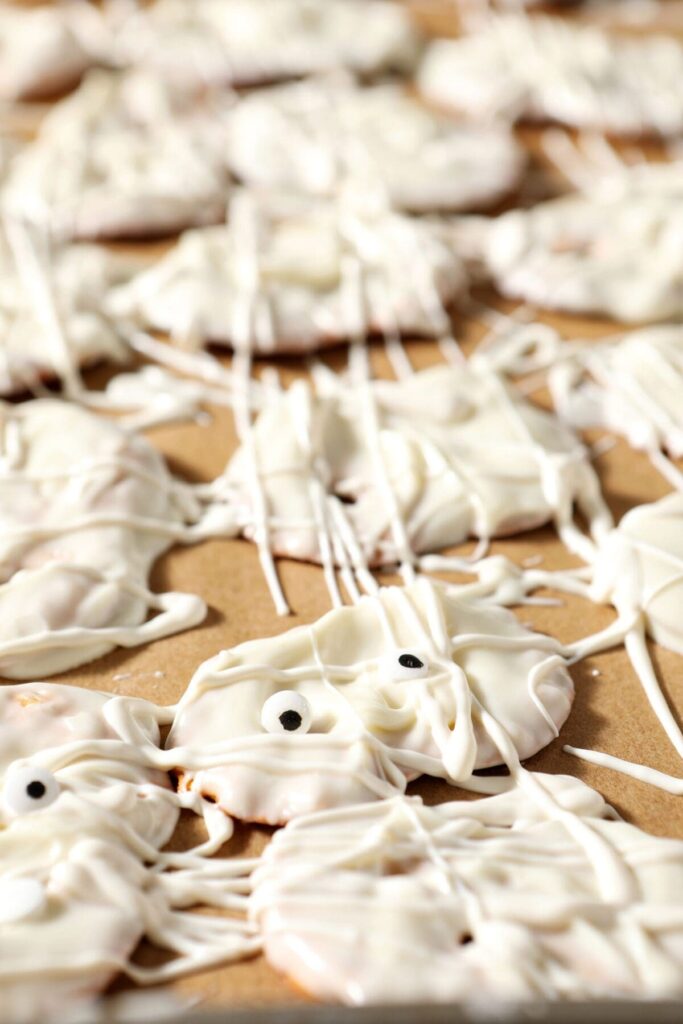 Pretzels decorated like mummies on parchment