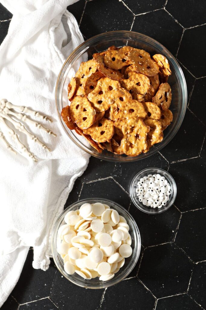 Pretzel crisps in a bowl with white chocolate wafers and candy eyeballs