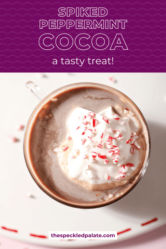 Close up of a peppermint patty drink garnished with whipped cream and crushed peppermint with the text spiked peppermint cocoa a tasty treat