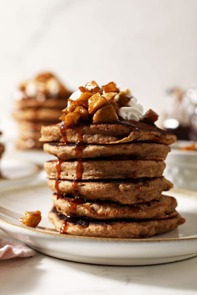 Close up of syrup dripping down the side of a stack of Apple Cider Pancakes