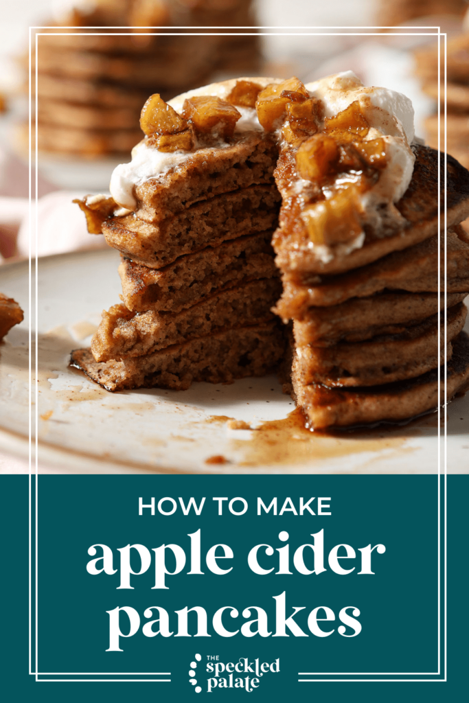 A cut-into stack of pancakes on a plate garnished with caramelized apples, whipped cream and syrup with the text how to make apple cider pancakes