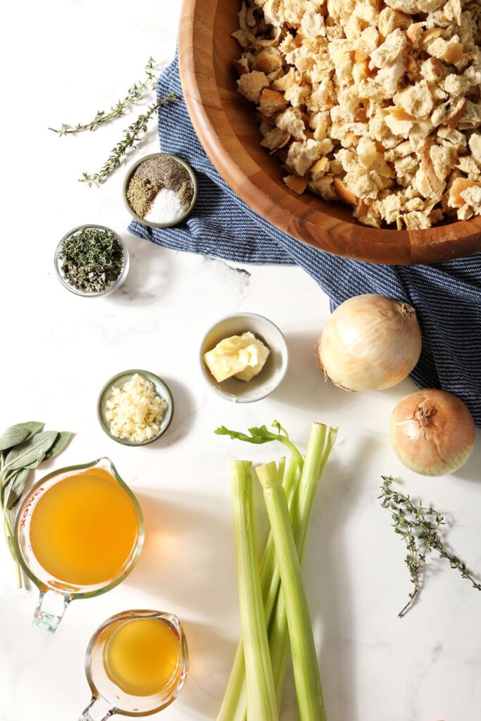 Ingredients to make white bread stuffing on a marble surface