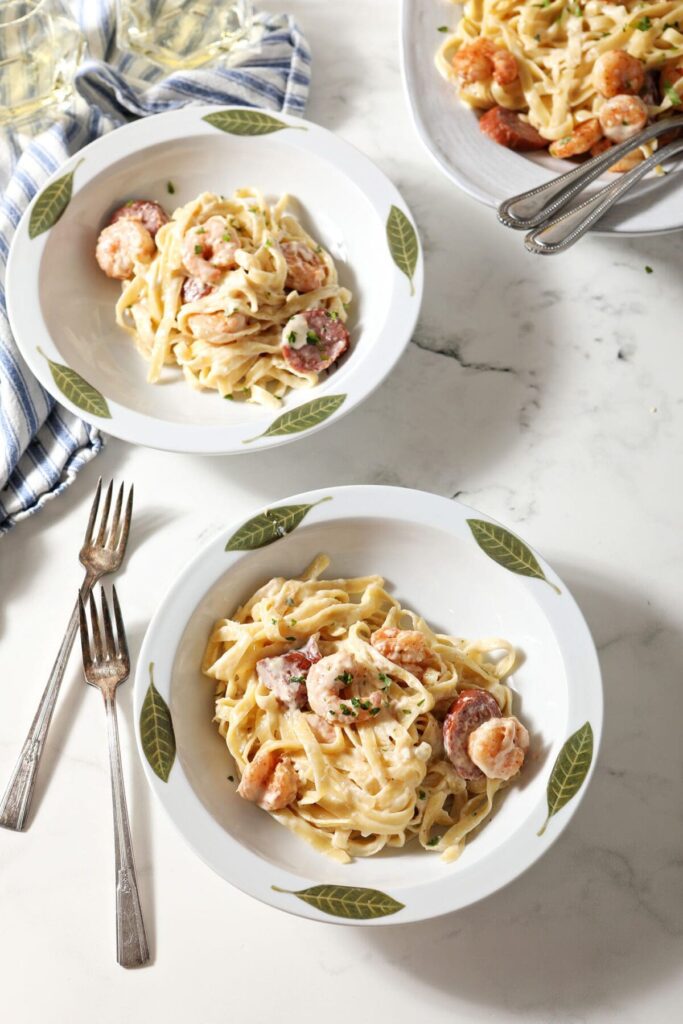 Three bowls of Shrimp Fettuccine Alfredo on marble