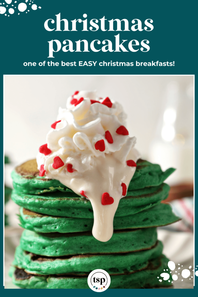 Close up of green pancakes topped with whipped cream and cream cheese frosting with red heart sprinkles with the text Christmas pancakes on elf the best EASY Christmas breakfasts