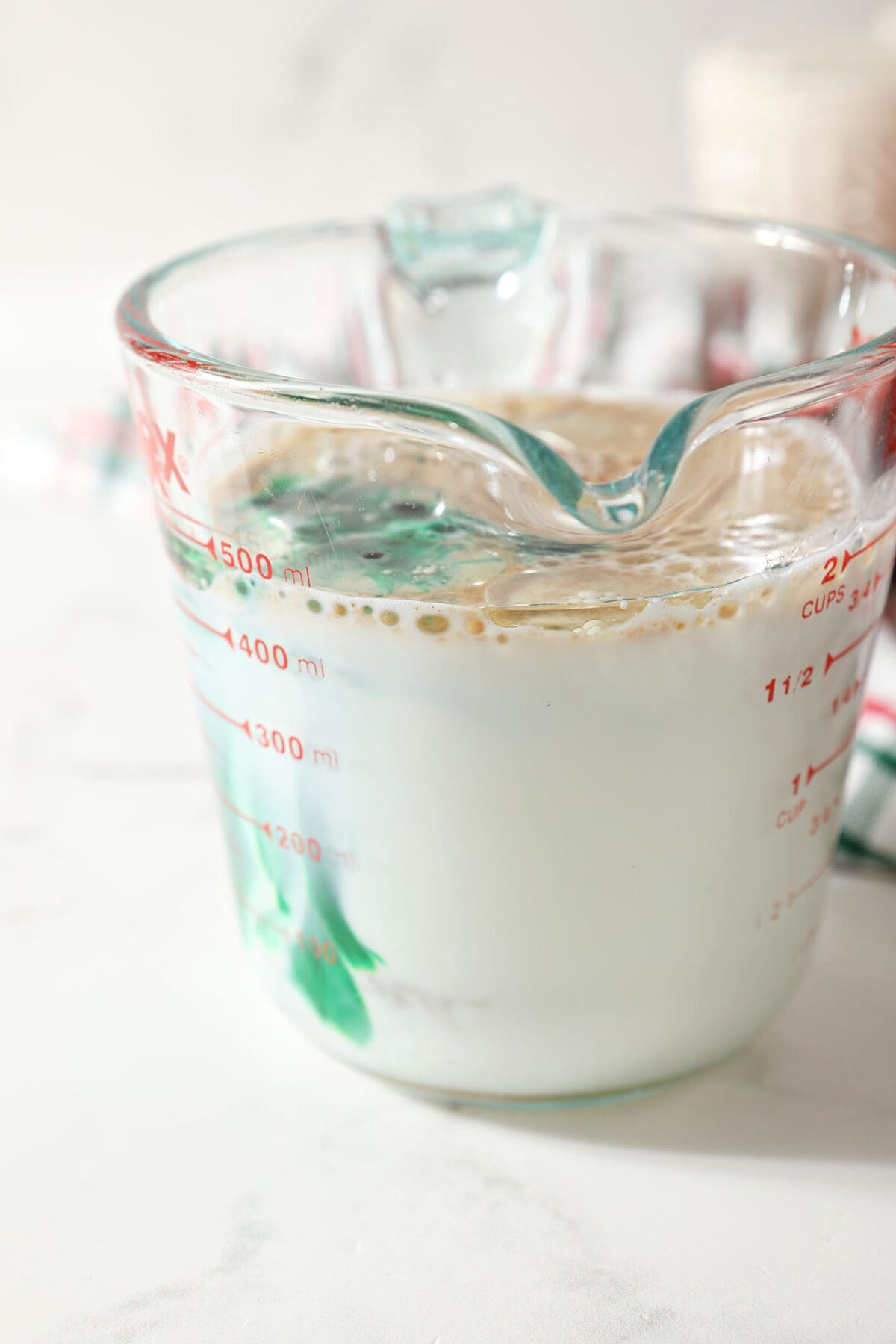 Wet ingredients in a liquid measuring cup before mixing