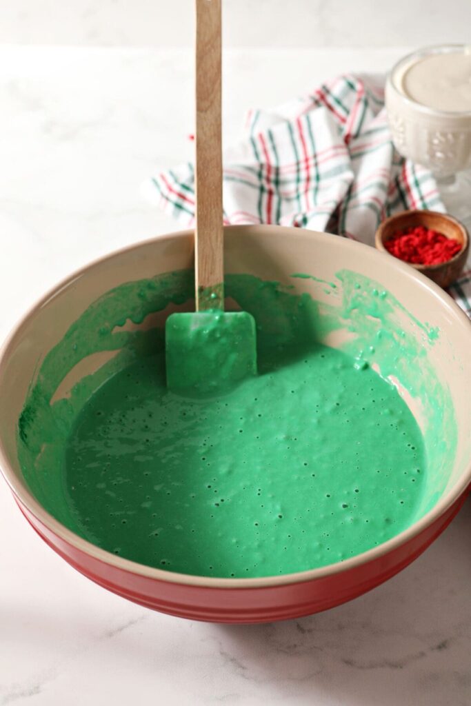 Bright green pancake batter in a red bowl