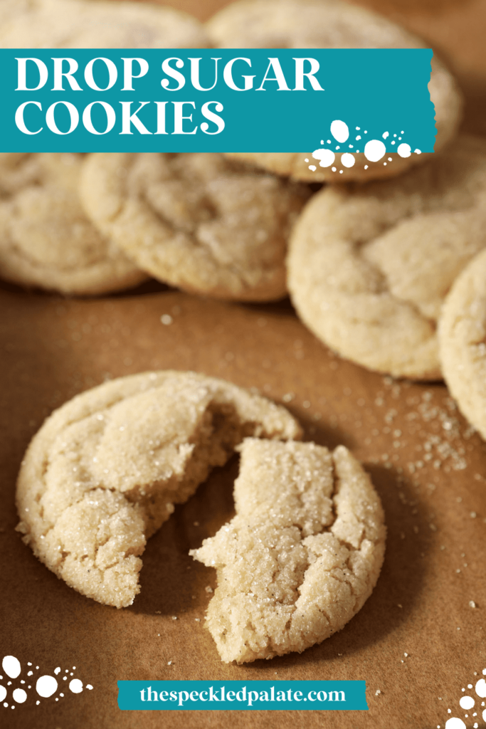 A halved round sugar cookie on parchment with other cookies with the text Drop Sugar Cookies