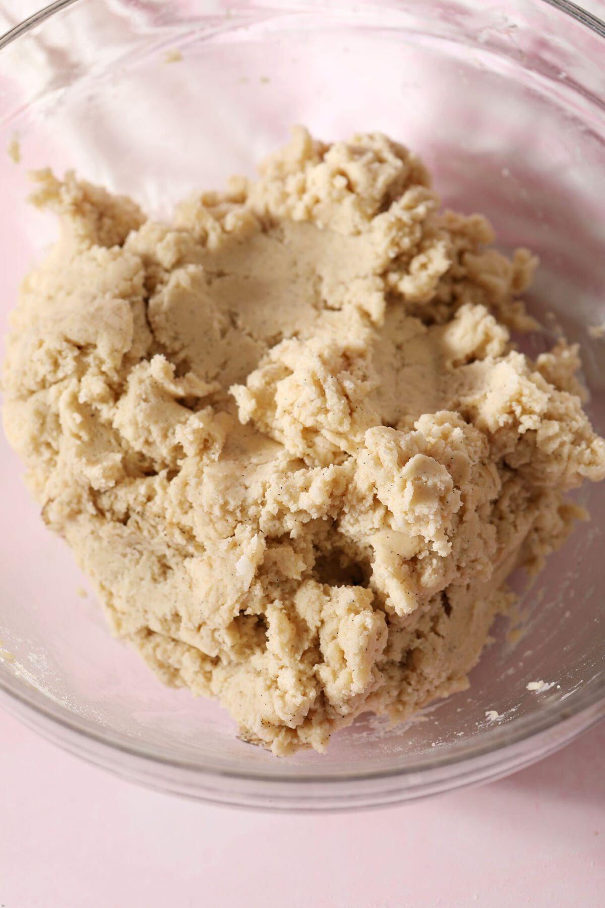 Cookie dough on a bowl on a pink countertop