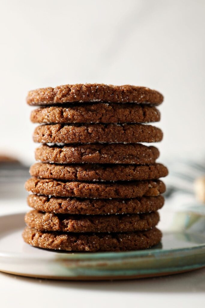 A stack of ginger snap cookies on a plate on marble