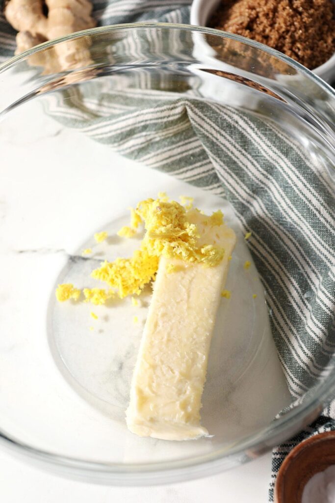 Butter and ground ginger in a bowl on marble