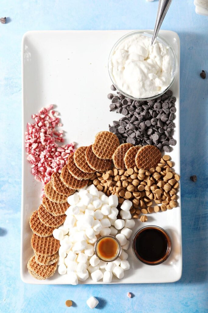 Sprinkles, chocolate chips, butterscotch chips and candy cane chips with other ingredients on a platter