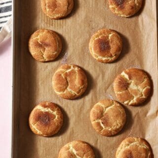 Crackly snickerdoodle cookies on a baking sheet