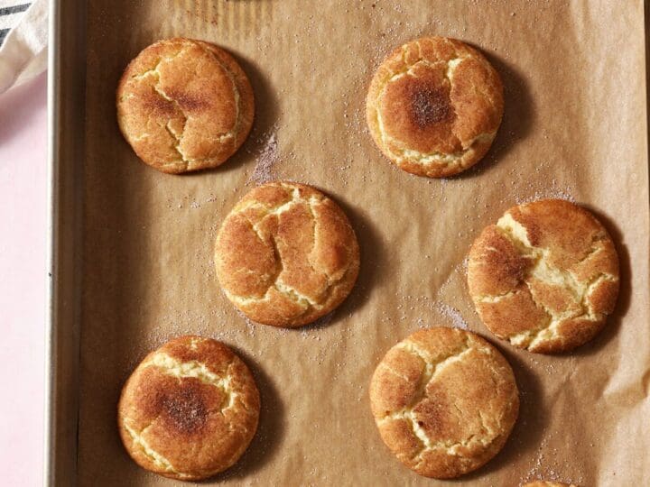 Crackly snickerdoodle cookies on a baking sheet