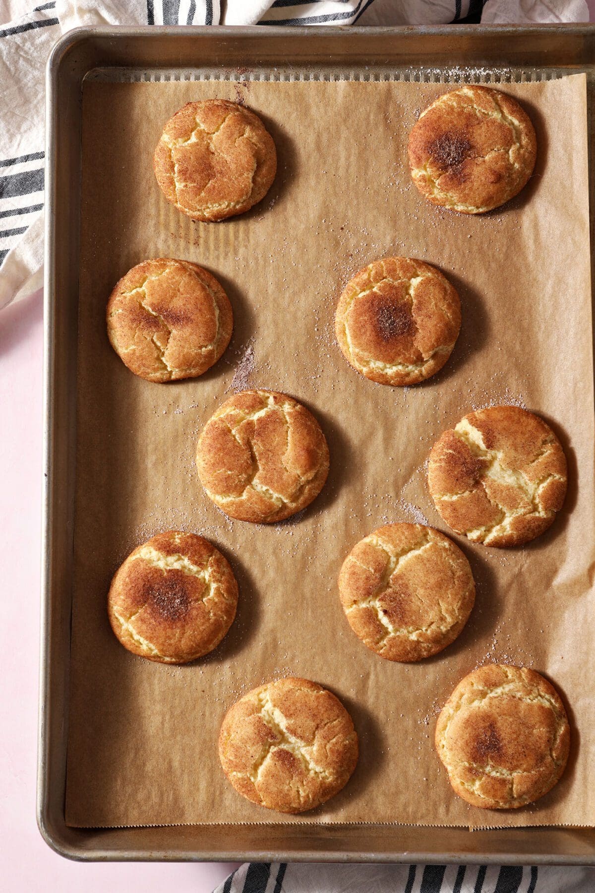 Crackly snickerdoodle cookies on a baking sheet