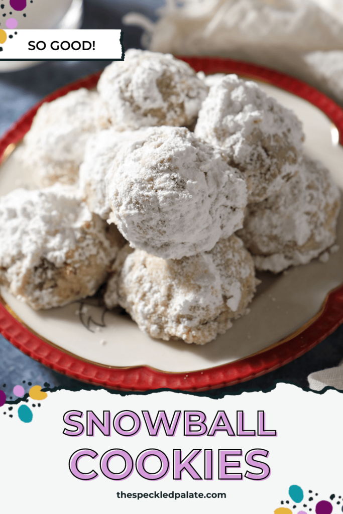 A red-rimmed plate of sugar-covered cookies on a blue countertop with the text snowball cookies