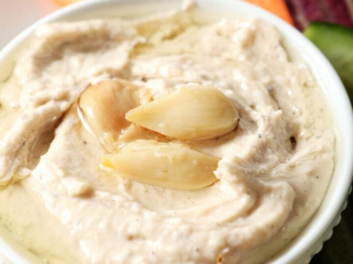 Close up of a serving bowl of Roasted Garlic White Bean Hummus