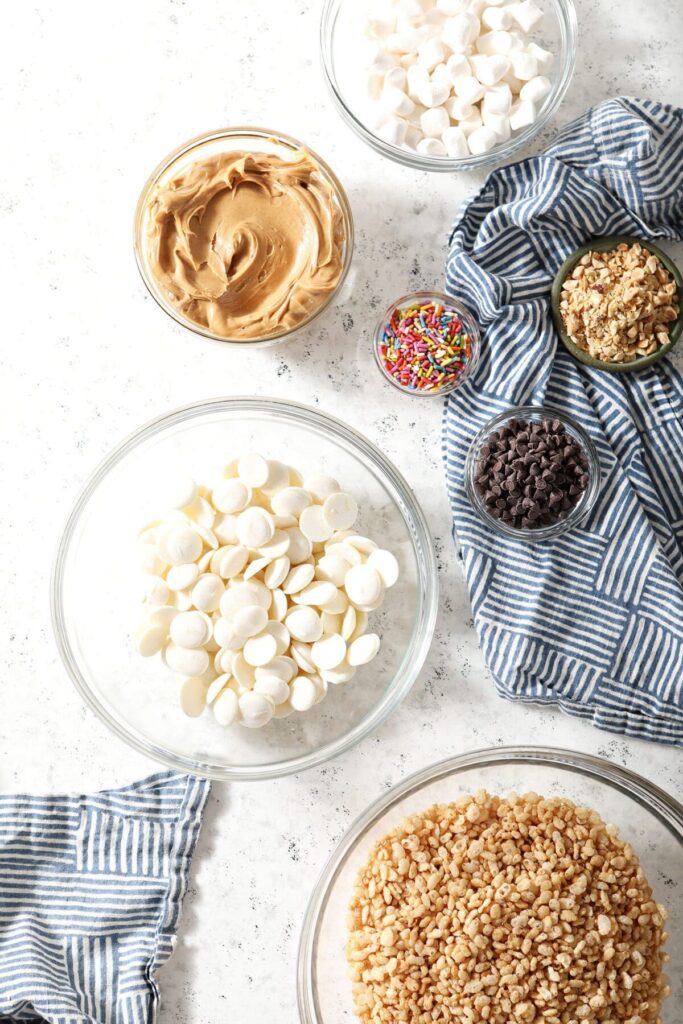 Ingredients to make no bake cookies in bowls on a marble countertop