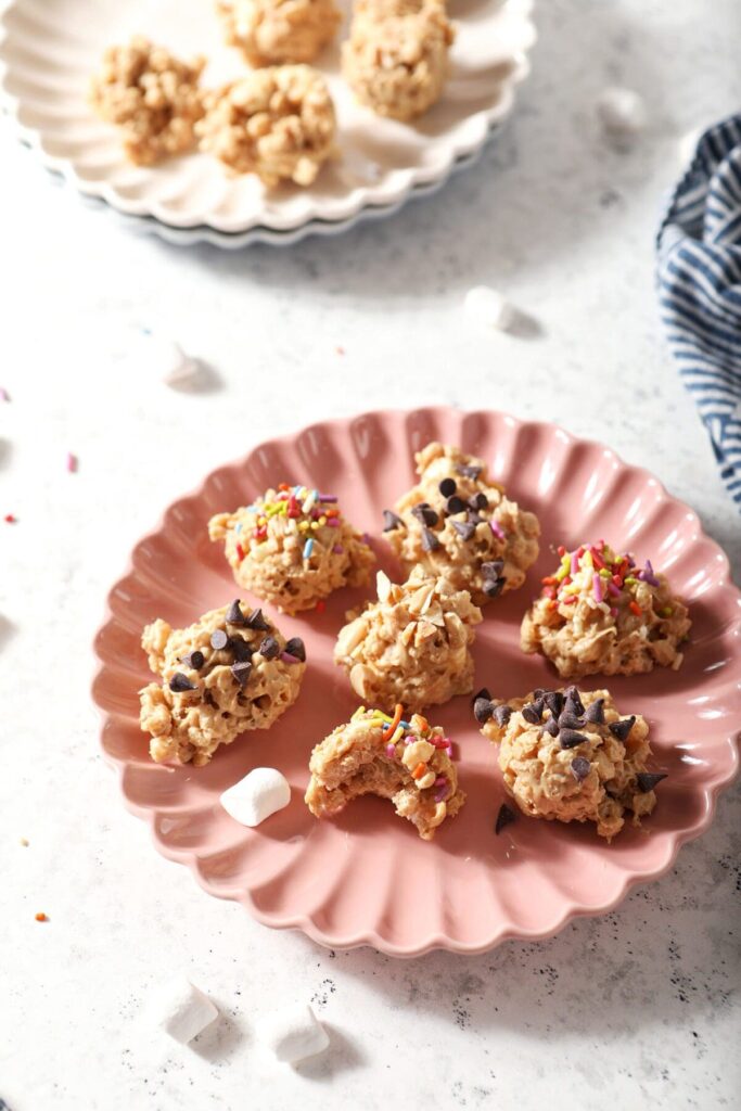 Several Avalanche Cookies on a pink plate on a marble backdrop