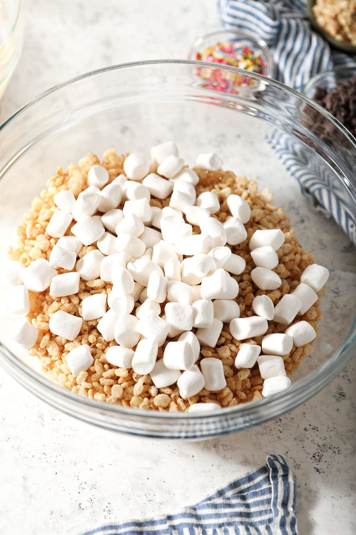 Rice Krispies and marshmallows in a bowl on marble