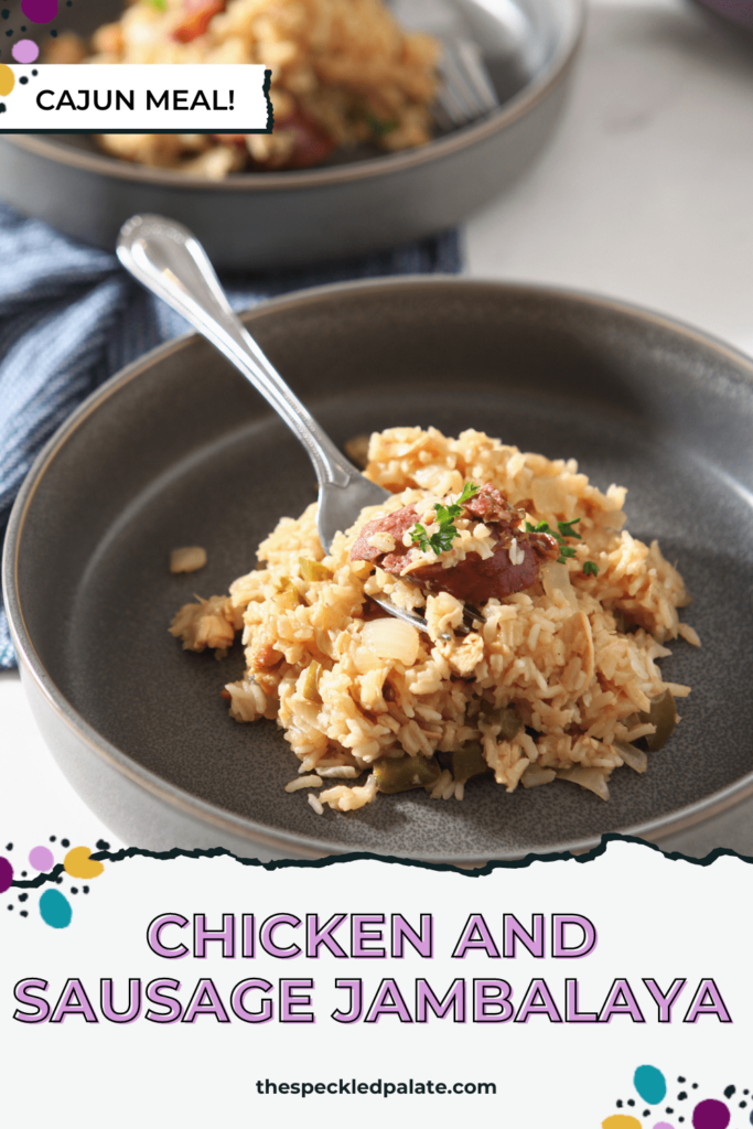 A gray bowl holds a rice dish with sausage and chicken in it with a fork with the text Chicken and Sausage Jambalaya