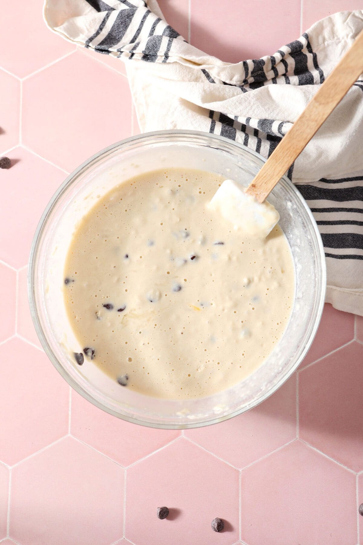 The Chocolate Chip Pancake batter in a bowl on a pink tile countertop