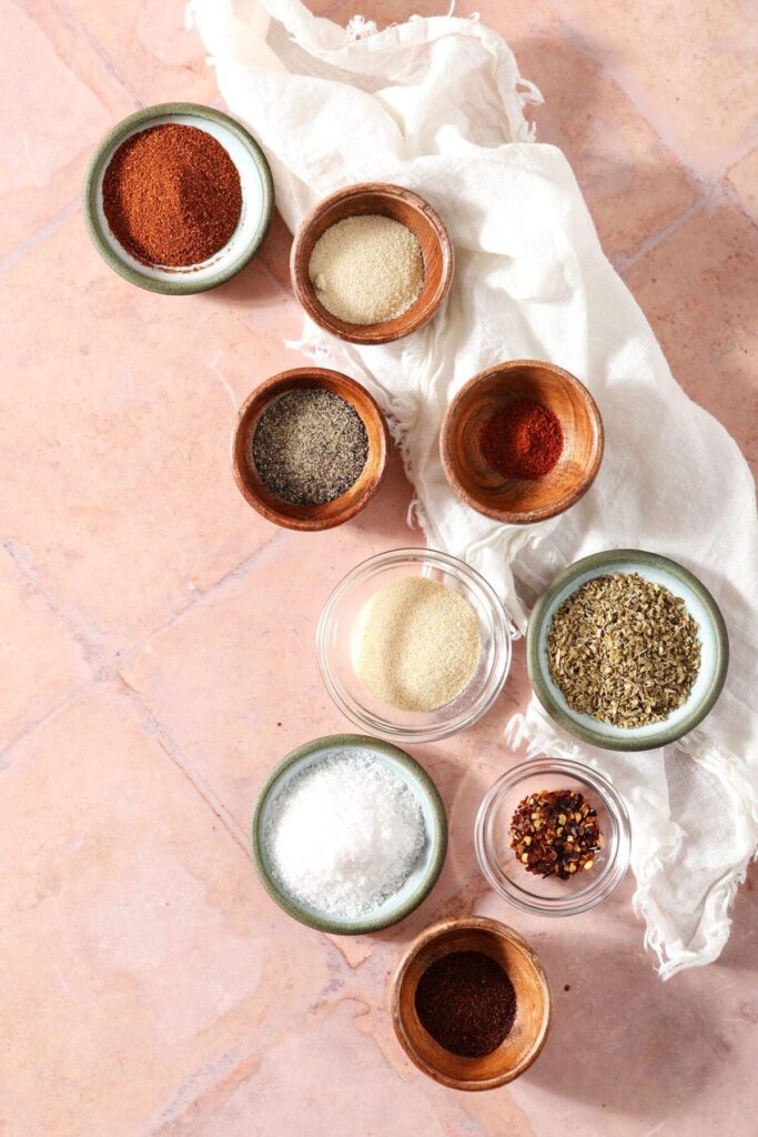 Spices and herbs in bowls before making into a creole seasoning blend