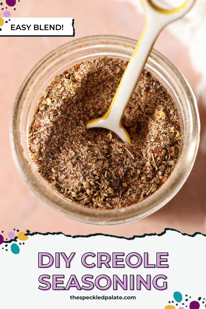 Closeup of a teaspoon in a homemade spice blend with the text DIY Creole seasoning