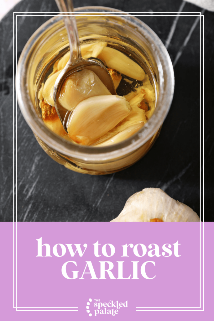 Roasted garlic cloves in a jar with a spoon and oil with the text how to roast garlic